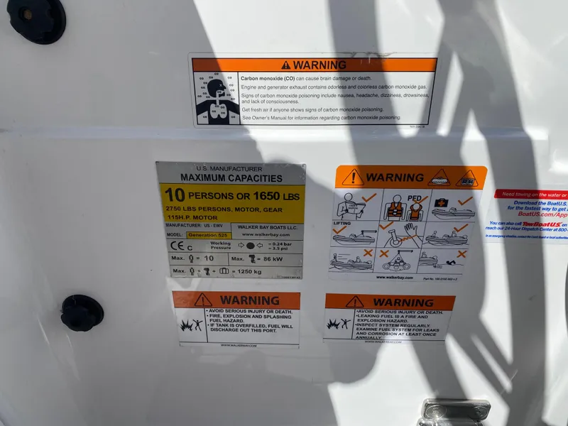 Slide: The Image of 2021 Walker Bay Generation 525 DLX capacity and safety warning labels on boat interior. - 42