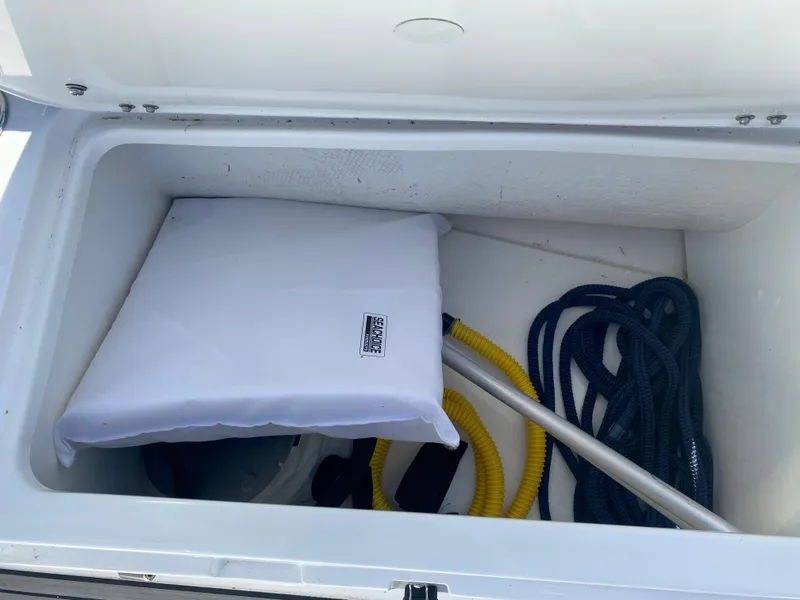 Slide: The Image of Storage compartment of 2021 Walker Bay Generation 525 DLX with cushion and ropes. - 46