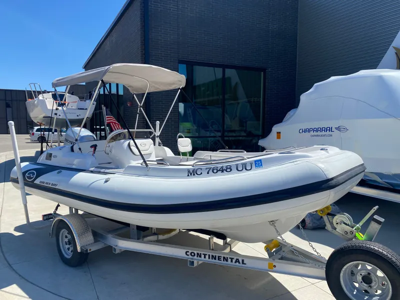 Slide: The Image of 2021 Walker Bay Generation 525 DLX boat on trailer, parked outside a building. - 5