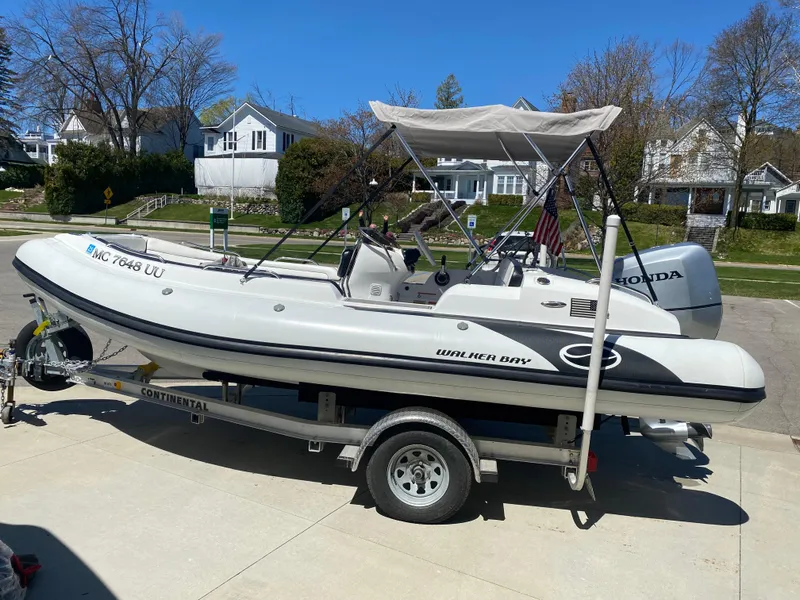 Slide: The Image of 2021 Walker Bay Generation 525 DLX boat on trailer, parked in residential driveway. - 8