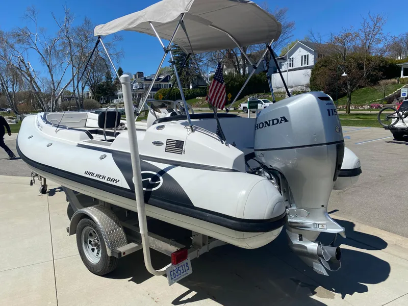 Slide: The Image of 2021 Walker Bay Generation 525 DLX boat with Honda outboard motor on a trailer. - 9