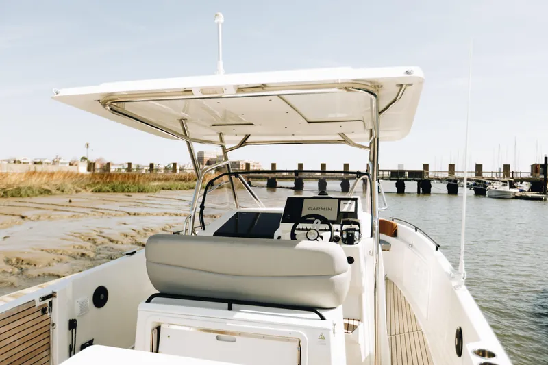 Slide: The Image of 2023 Beneteau Flyer 9 SPACEdeck boat docked near a scenic shoreline. - 3