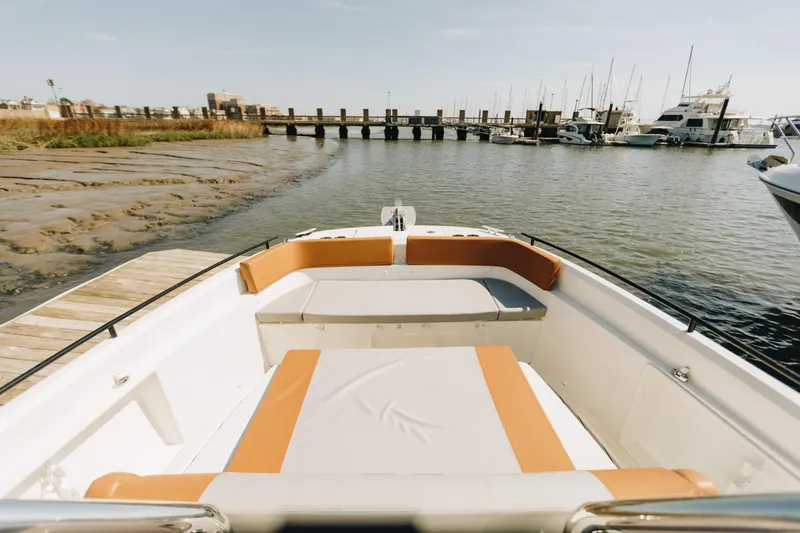 Slide: The Image of 2023 Beneteau Flyer 9 SPACEdeck boat at marina, featuring spacious seating and scenic waterfront view. - 4