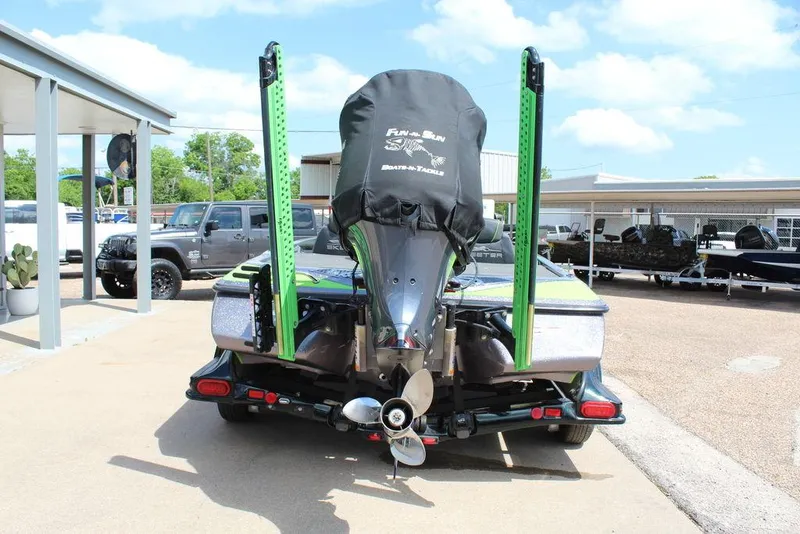 Slide: The Image of 2017 Skeeter FX20 LE boat with motor cover and green accents, parked outdoors. - 10