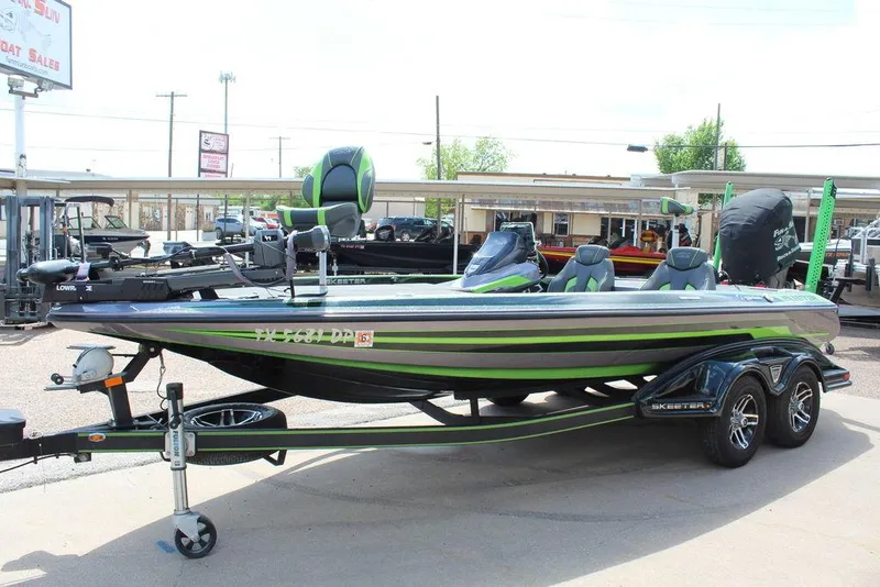 Slide: The Image of 2017 Skeeter FX20 LE bass boat with trailer, featuring sleek design and vibrant accents. - 6