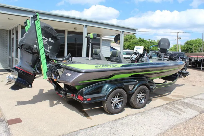 Slide: The Image of 2017 Skeeter FX20 LE bass boat with trailer, parked outdoors. - 9