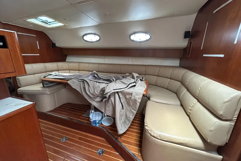 Slide: The Image of 1999 Tiara Yachts 400 Express cabin with leather seating and wooden interior. - 11