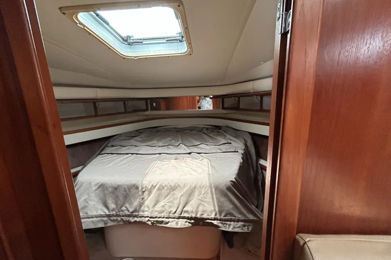 Slide: The Image of 1999 Tiara Yachts 400 Express cabin interior with bed and skylight. - 12