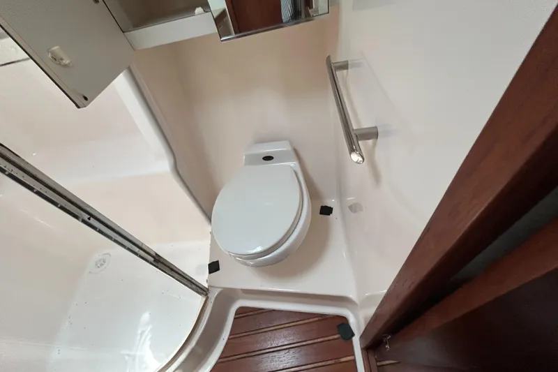 Slide: The Image of 1999 Tiara Yachts 400 Express bathroom with toilet and shower area. - 13