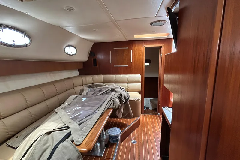 Slide: The Image of 1999 Tiara Yachts 400 Express cabin interior with wood finish and seating area. - 17