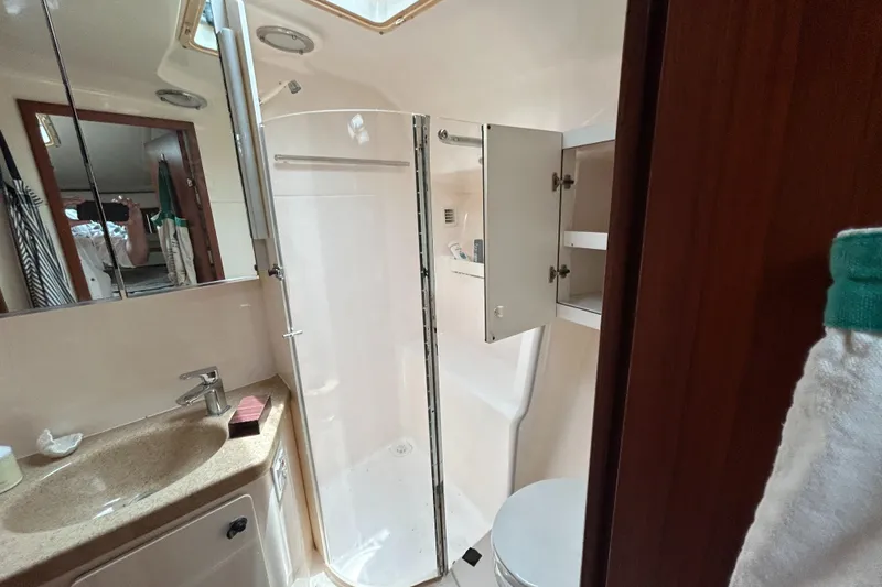 Slide: The Image of Bathroom interior of 1999 Tiara Yachts 400 Express with shower and vanity. - 18