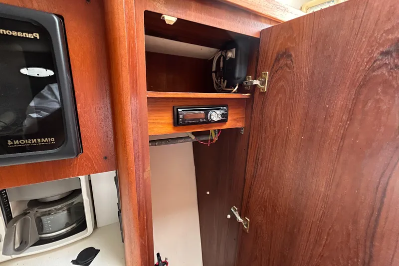 Slide: The Image of 1999 Tiara Yachts 400 Express interior cabinet with stereo and microwave. - 27