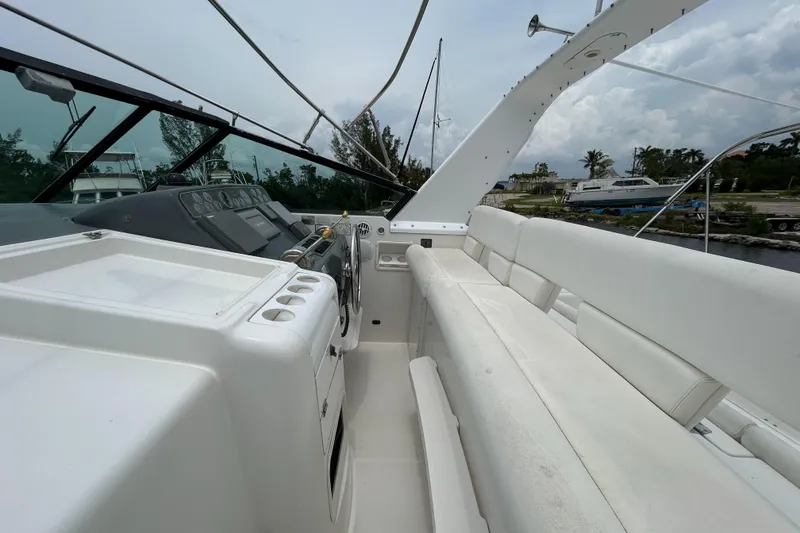 Slide: The Image of 1999 Tiara Yachts 400 Express cockpit with white seating and control panel. - 28