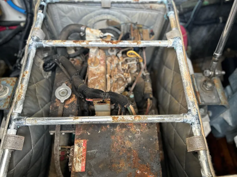 Slide: The Image of Engine compartment of a 1999 Tiara Yachts 400 Express, showing rust and wear. - 3