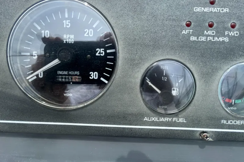 Slide: The Image of Dashboard of a 1999 Tiara Yachts 400 Express showing RPM and fuel gauges. - 31