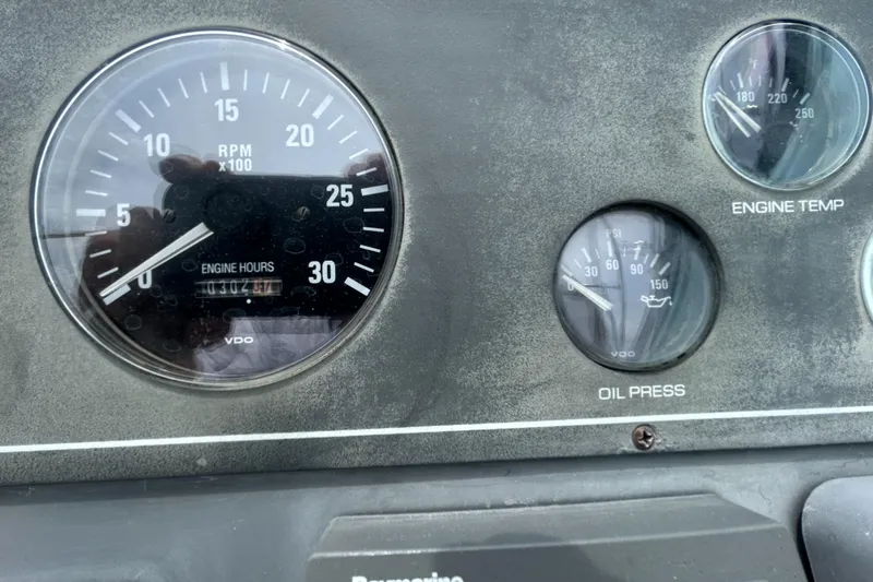 Slide: The Image of Dashboard gauges of a 1999 Tiara Yachts 400 Express, showing RPM, engine temperature, and oil pressure. - 32