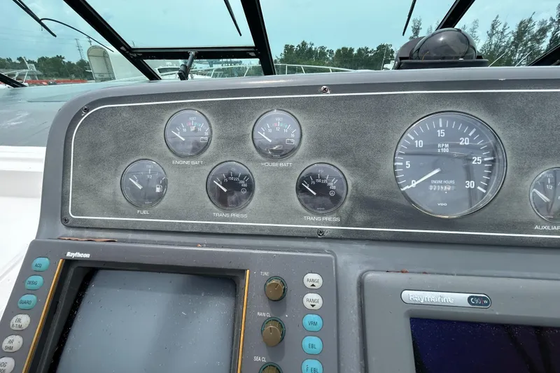 Slide: The Image of Dashboard of a 1999 Tiara Yachts 400 Express with gauges and controls. - 33