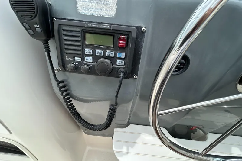 Slide: The Image of 1999 Tiara Yachts 400 Express helm with radio and steering wheel. - 35