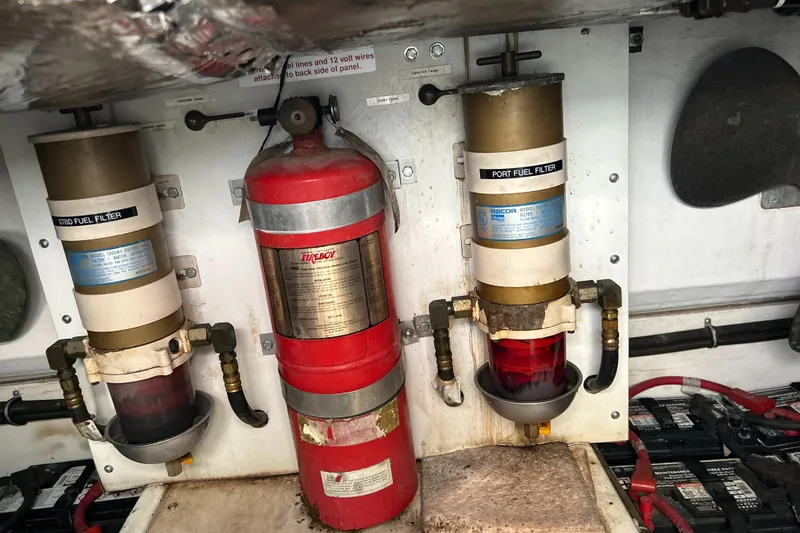 Slide: The Image of Engine room of 1999 Tiara Yachts 400 Express with fire extinguisher and fuel filters. - 42