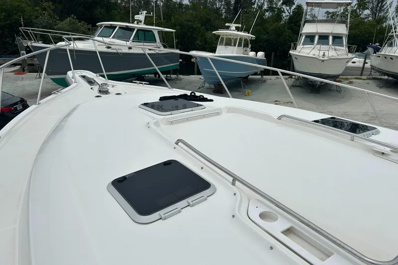 Slide: The Image of 1999 Tiara Yachts 400 Express on deck, surrounded by other boats in a marina. - 45