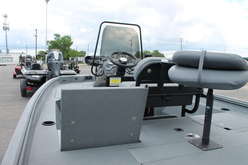 Slide: The Image of 2024 Excel Bay Pro Elite 183 boat interior with steering console and seating. - 5