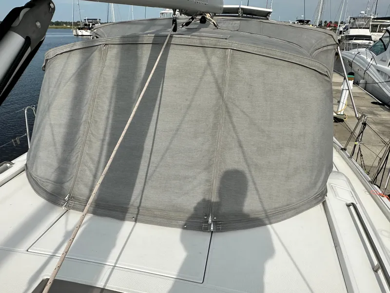 Slide: The Image of 2023 Beneteau Oceanis 46.1 yacht with covered cockpit, docked at marina. - 15