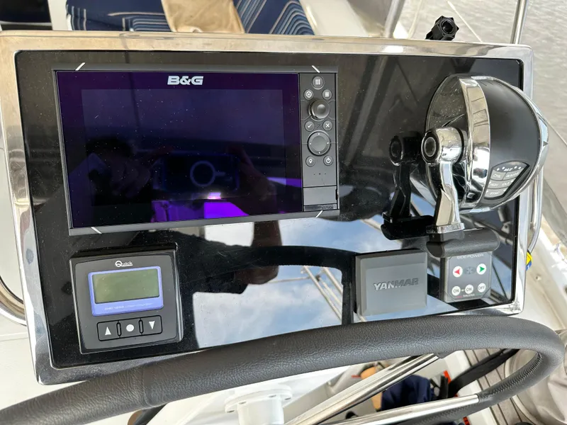 Slide: The Image of Control panel of a 2023 Beneteau Oceanis 46.1 yacht with navigation and throttle systems. - 27