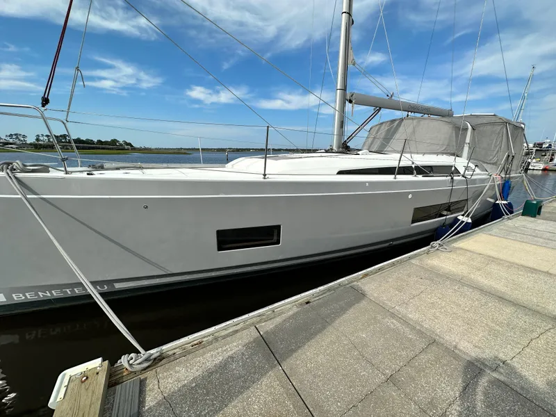 Slide: The Image of 2023 Beneteau Oceanis 46.1 yacht docked at marina under blue sky. - 3