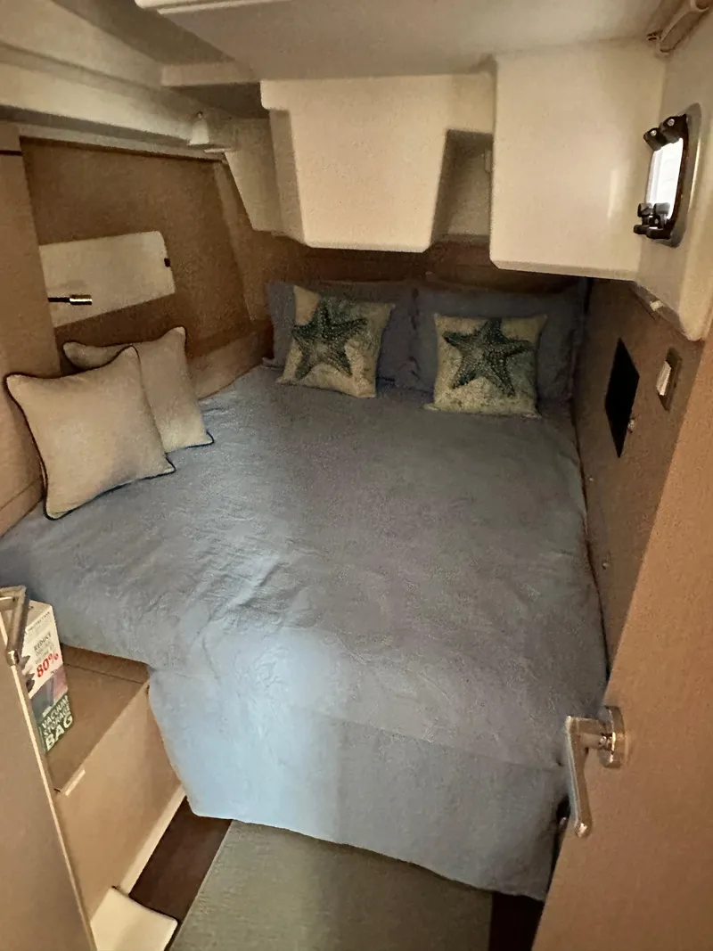 Slide: The Image of Cozy cabin interior of 2023 Beneteau Oceanis 46.1 with starfish-themed bedding. - 45