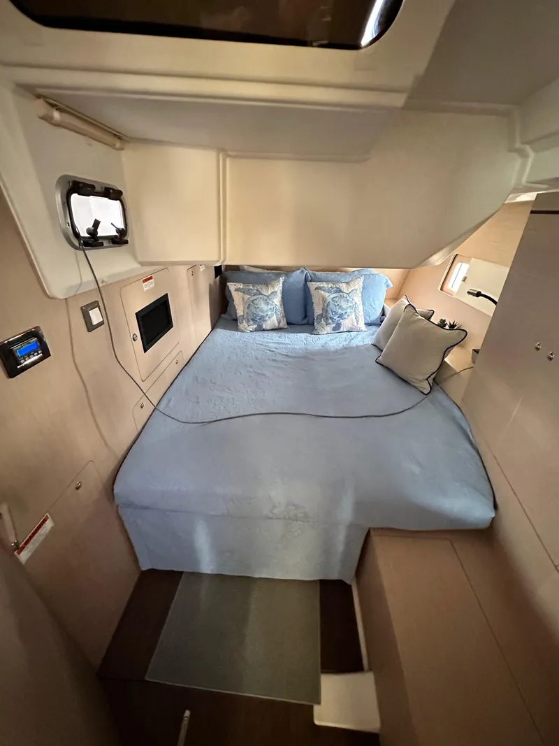 Slide: The Image of Interior cabin of 2023 Beneteau Oceanis 46.1 yacht with cozy bed and blue bedding. - 47