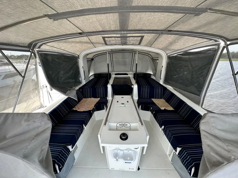 Slide: The Image of Interior view of 2023 Beneteau Oceanis 46.1 sailboat with striped seating and covered deck. - 5