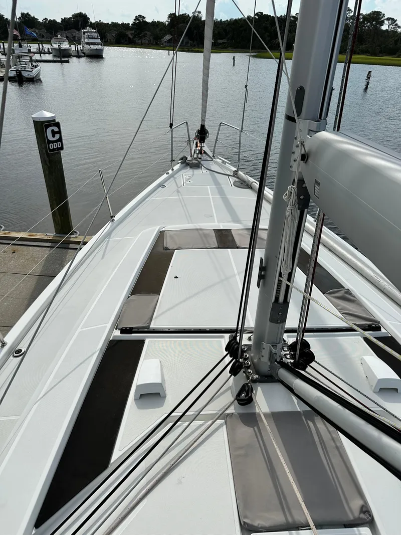 Slide: The Image of 2023 Beneteau Oceanis 46.1 sailboat docked at a marina, viewed from the deck. - 6