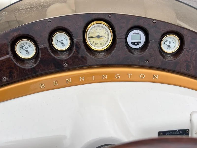 Slide: The Image of Dashboard of 2004 Bennington 2575 RLX boat with gauges and brand logo. - 12