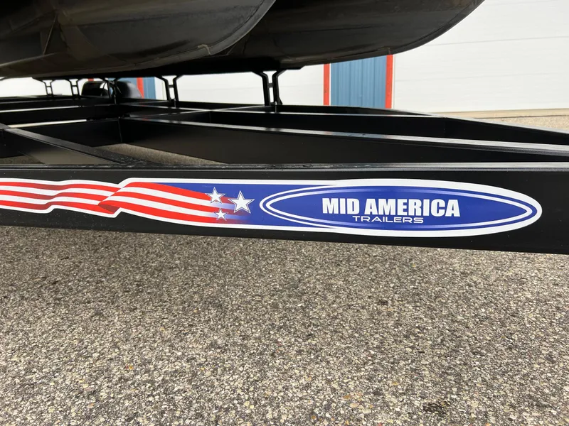 Slide: The Image of Trailer with "Mid America Trailers" logo, supporting a 2004 Bennington 2575 RLX boat. - 13