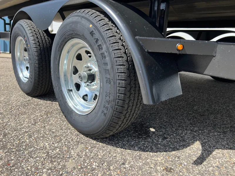 Slide: The Image of Trailer wheels of a 2004 Bennington 2575 RLX on asphalt surface. - 20