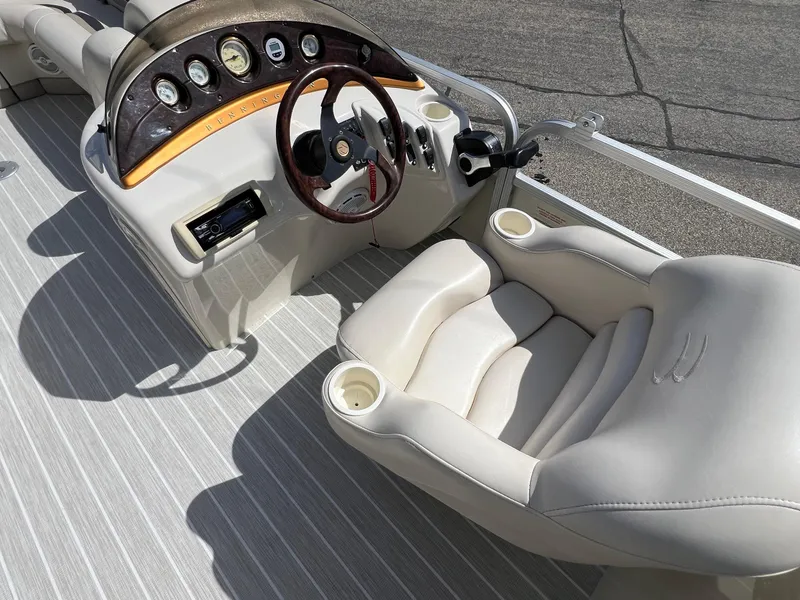 Slide: The Image of 2004 Bennington 2575 RLX boat interior with steering wheel and cushioned seating. - 28