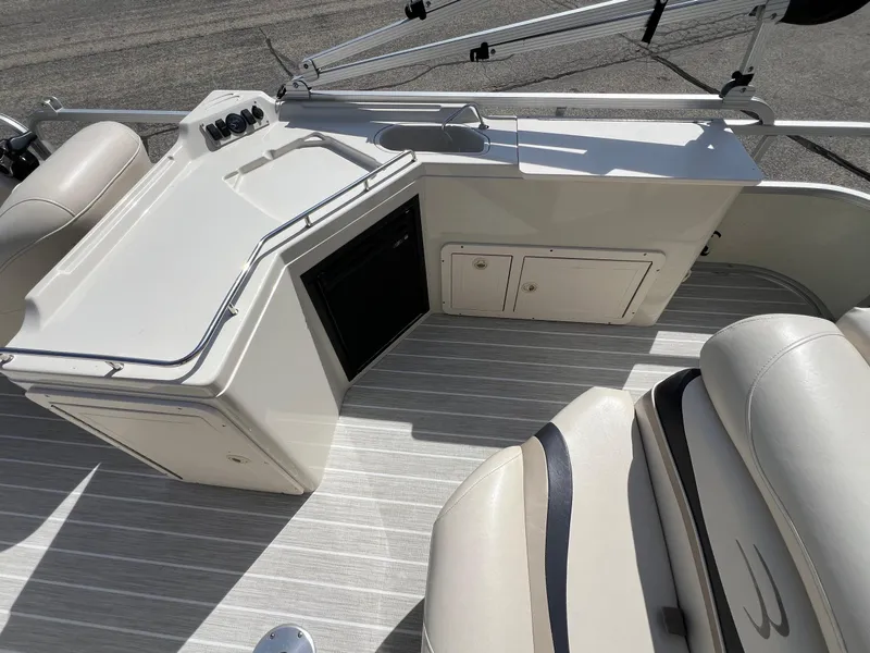 Slide: The Image of 2004 Bennington 2575 RLX boat interior with seating and storage compartments. - 31