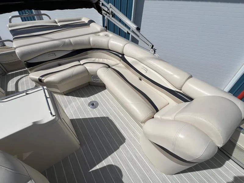 Slide: The Image of 2004 Bennington 2575 RLX boat with beige leather seating and striped flooring. - 32