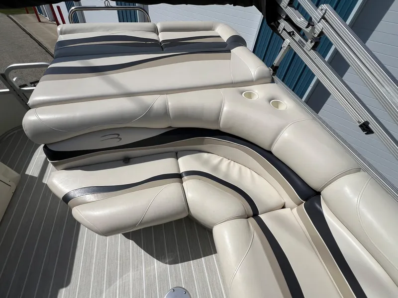 Slide: The Image of Luxurious seating on a 2004 Bennington 2575 RLX boat with striped upholstery. - 33