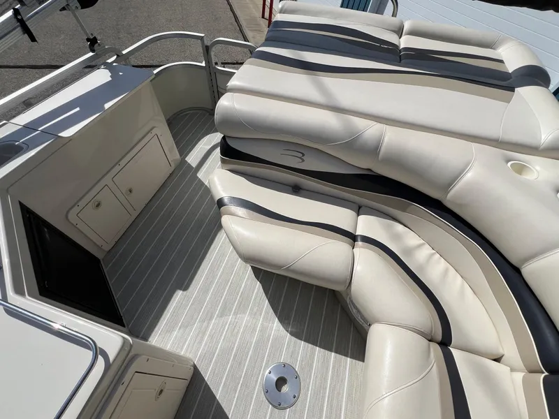 Slide: The Image of 2004 Bennington 2575 RLX boat interior with beige seating and striped flooring. - 34