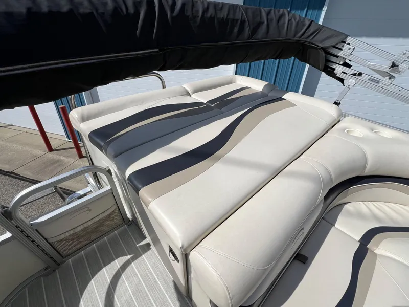 Slide: The Image of 2004 Bennington 2575 RLX boat with beige seating and striped upholstery. - 36