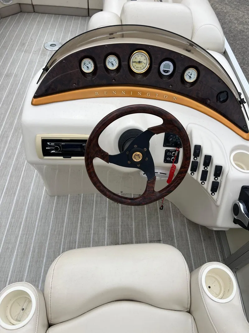 Slide: The Image of 2004 Bennington 2575 RLX boat dashboard with gauges and steering wheel. - 4