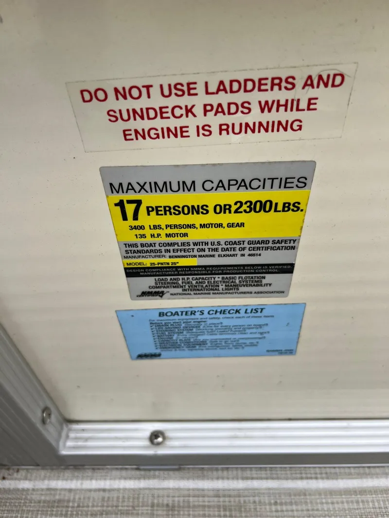 Slide: The Image of Warning and capacity labels on a 2004 Bennington 2575 RLX boat. - 5