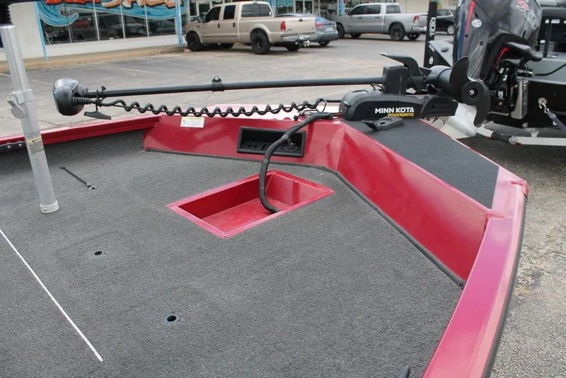 Slide: The Image of 2018 Lowe Stinger 175C boat with Minn Kota trolling motor, red deck, and storage compartment. - 2