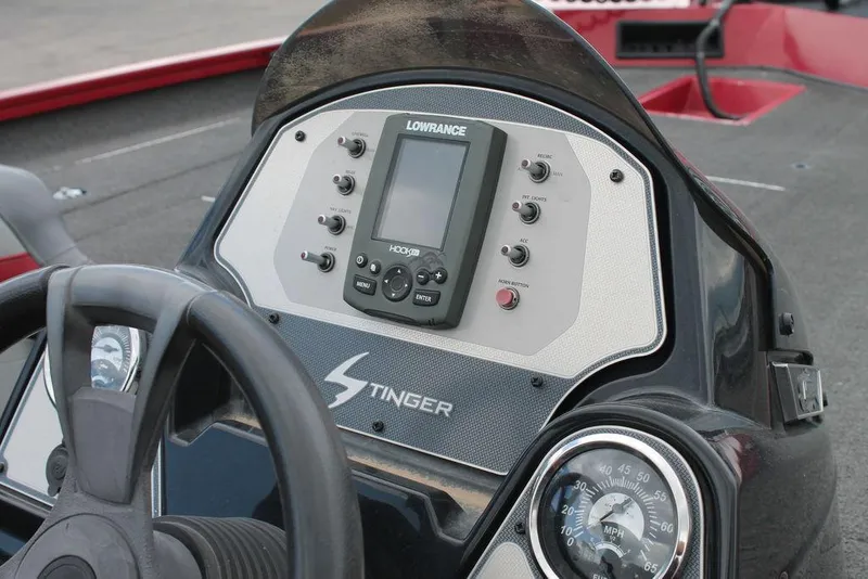 Slide: The Image of 2018 Lowe Stinger 175C dashboard with Lowrance fishfinder and steering wheel. - 4