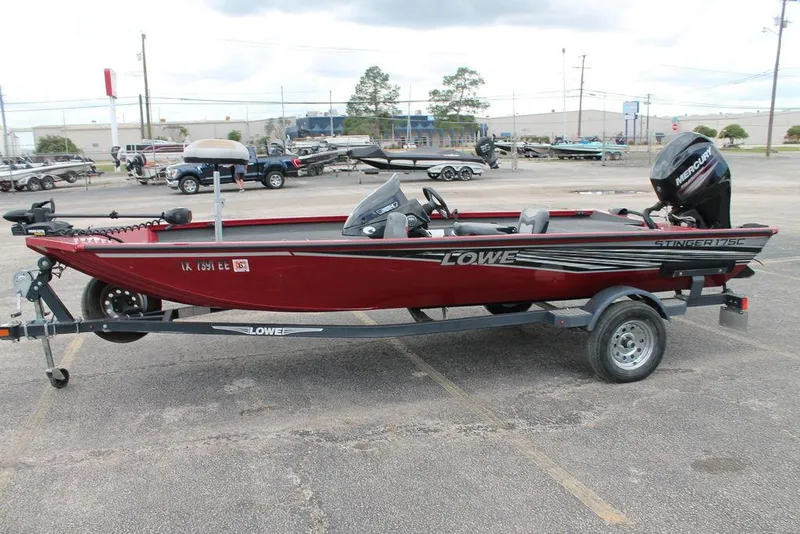 Slide: The Image of 2018 Lowe Stinger 175C fishing boat on trailer in parking lot. - 5
