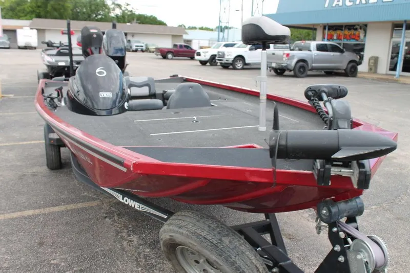 Slide: The Image of 2018 Lowe Stinger 175C boat on trailer, red exterior, parked in lot. - 7