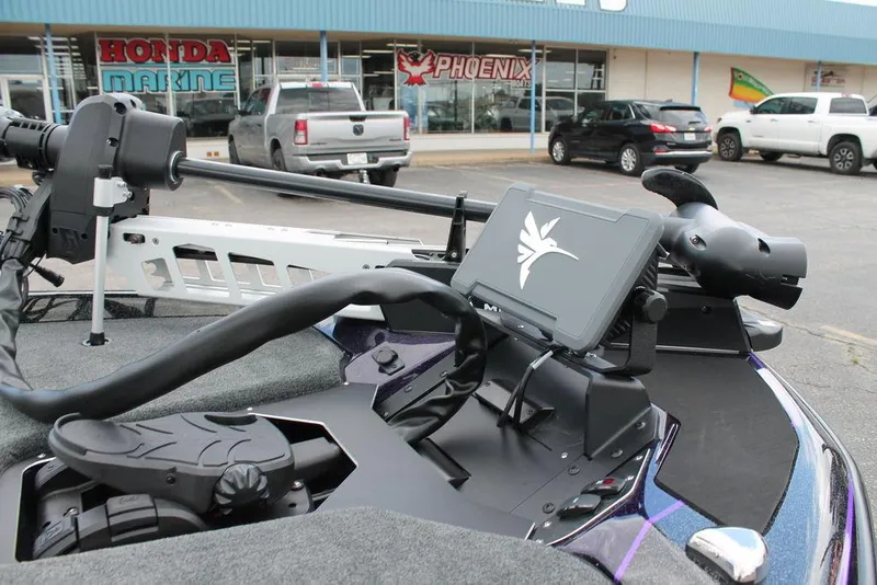 Slide: The Image of 2025 Skeeter ZXR19 boat dashboard with advanced navigation system, parked outside a marine store. - 1