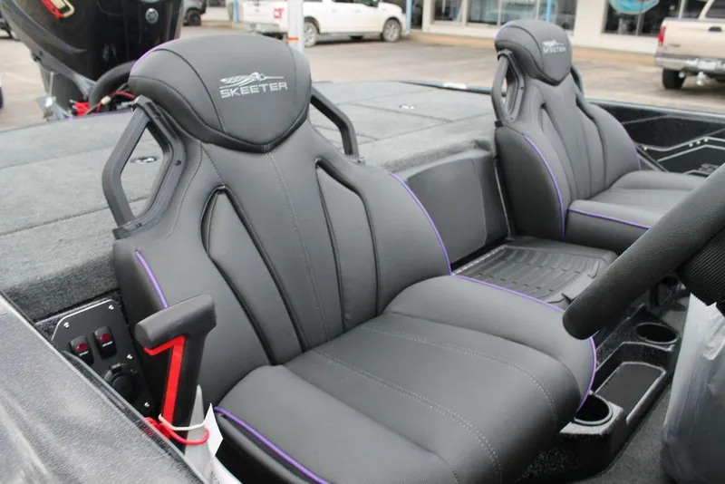 Slide: The Image of 2025 Skeeter ZXR19 boat seats with sleek black design and purple accents. - 2