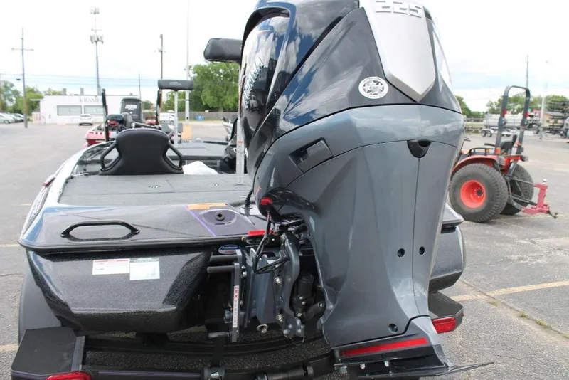 Slide: The Image of 2025 Skeeter ZXR19 boat with powerful outboard motor in a parking lot. - 3